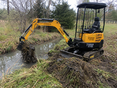 TYPHON TERROR XVIII mini excavator cleaning a ditch and improving water flow